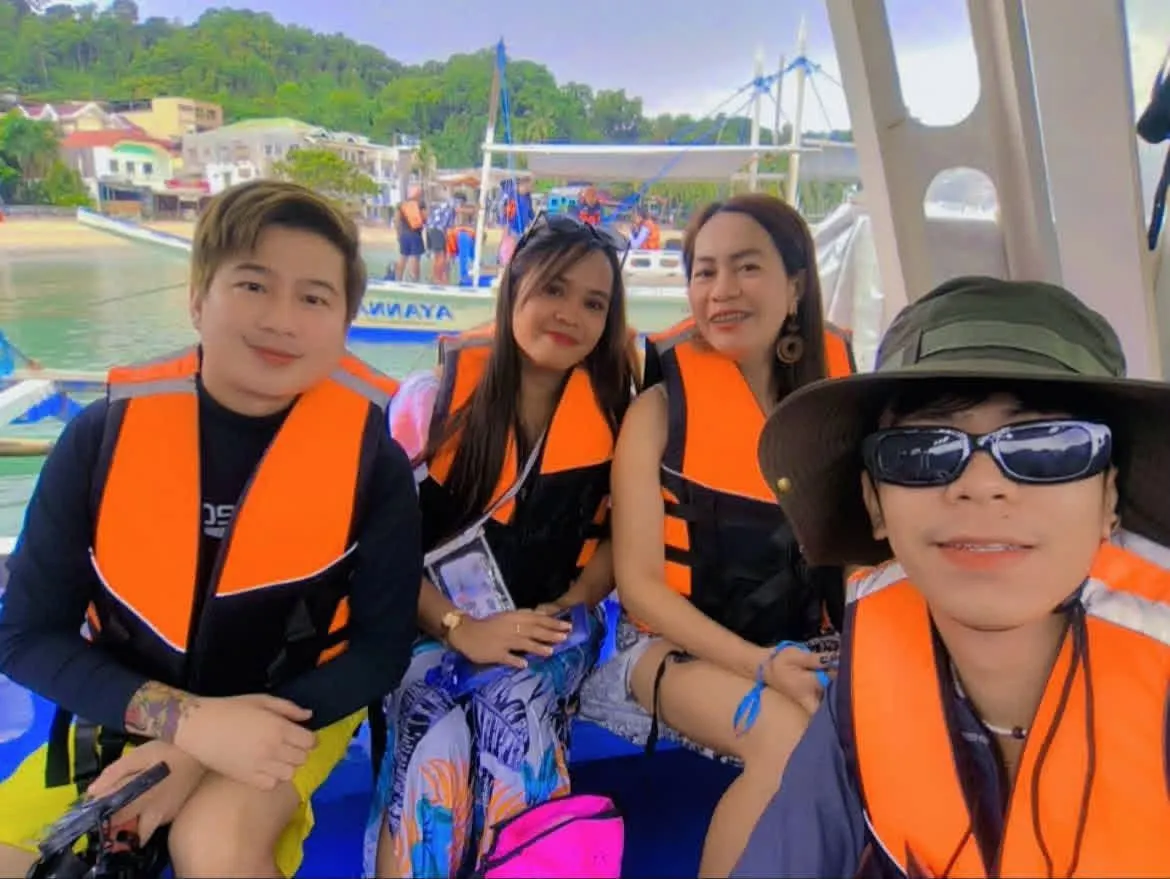 Guests in life vests smiling on the boat