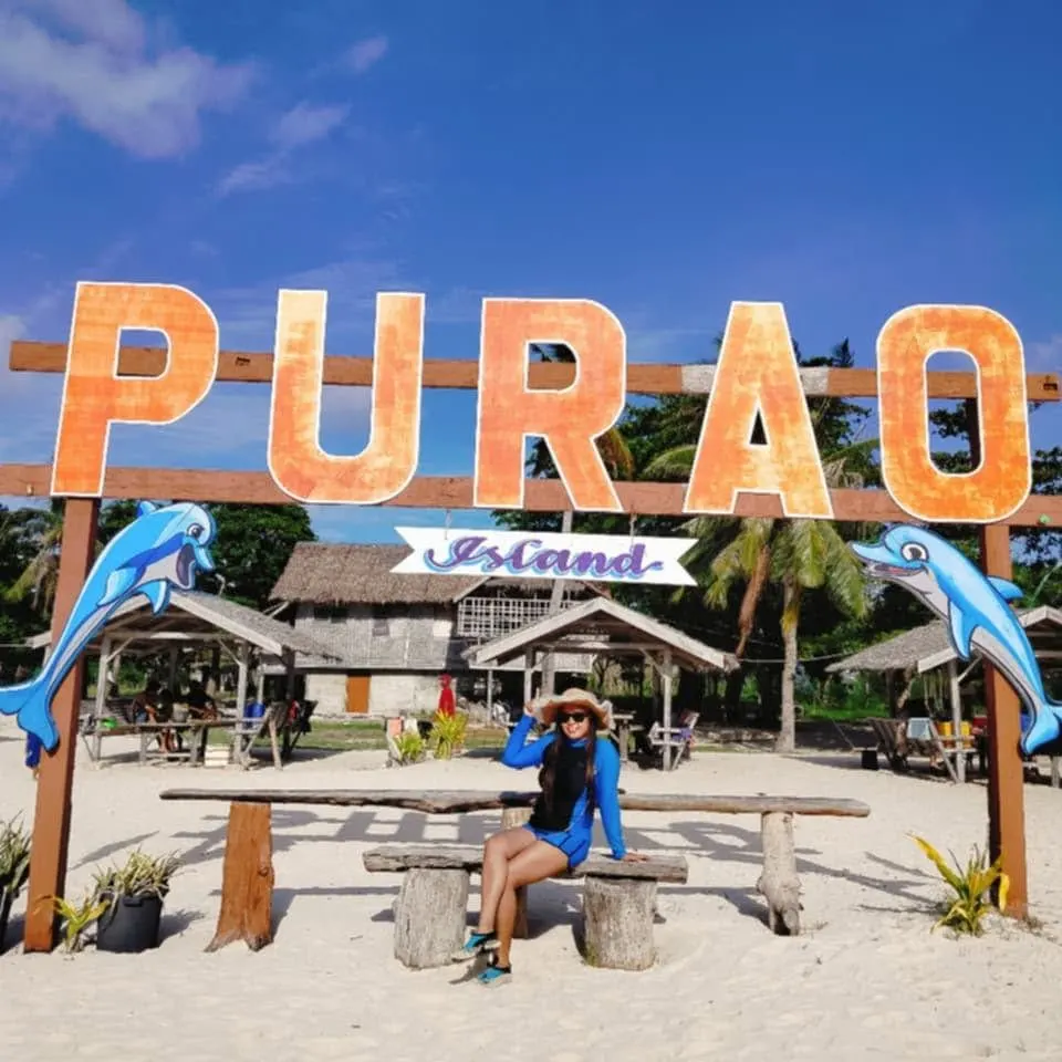 A guest at the Purao Island sign